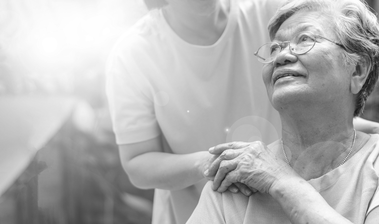 Caregiver holding the hand of someone in hospice care