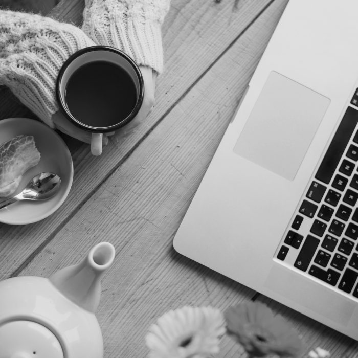 Overhead shot of adult with tea and laptop, having a first online therapy session