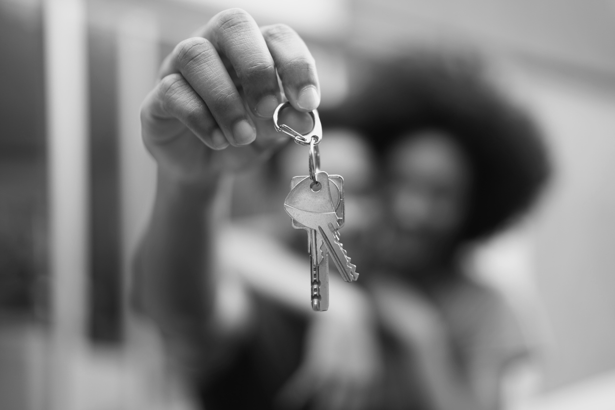 Young couple holding keys to their new apartment