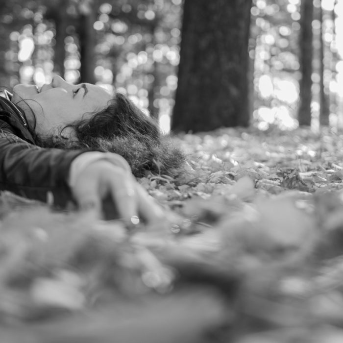 Person lying down in the fall leaves