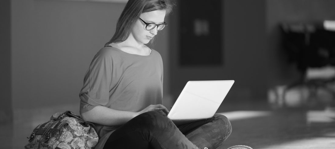 LGBTQ-affirming clinical supervision for therapists image of a person on their laptop
