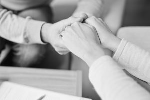 LGBTQ-affirming Peer Consultation image of hands clasped together